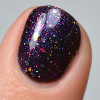 black jelly nail polish with color shifting flakies and glitter swatch