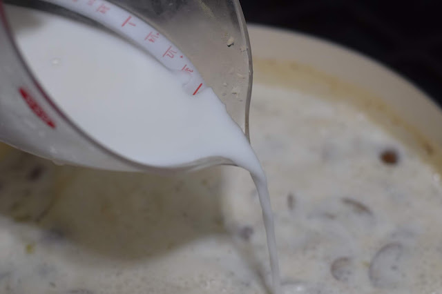 A cornstarch slurry being added to the pan on the stove. 