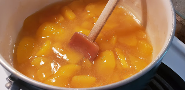 Cooking a pot of of peaches