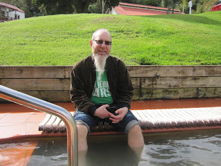 Martin soaking his feet and calves in an open-air foot pool