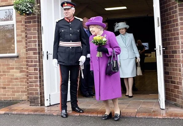 Queen Elizabeth II visited the King George VI Day Centre in Windsor. 60th anniversary of its establishment. The Queen wearing purple coat and hat