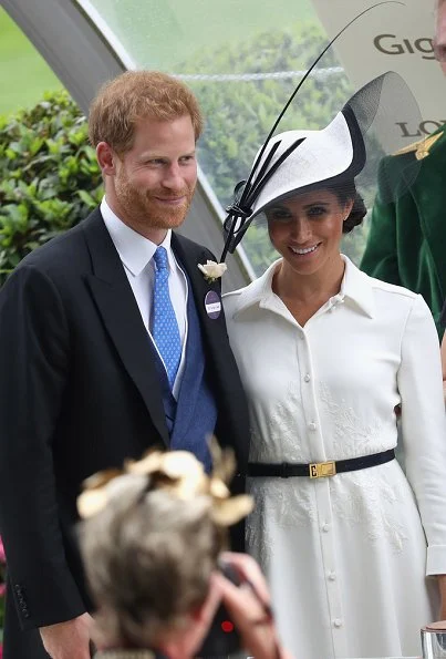 Duchess Meghan Markle wore a bespoke white shirt-style dress by Givenchy and carried a black handbag by the same brand Givenchy