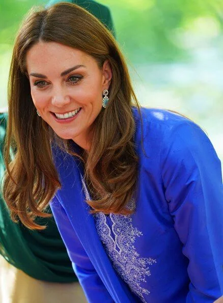 Kate Middleton wore a blue Kurta and trousers by Pakistani designer Maheen Khan and the Zeen earrings. Catherine Walker tunic