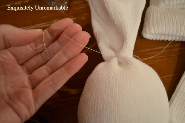Using thread to craft a sock angel