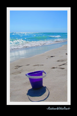 photo of: purple pail on the beach, bucket in the sand, reflection on waves in the ocean