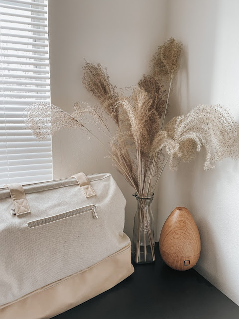 Beige Weekender Bag with Pampas and a tan diffuser in the background