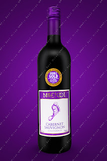 A bottle of Barefoot branded Cabernet Sauvignion California red wine on violet background
