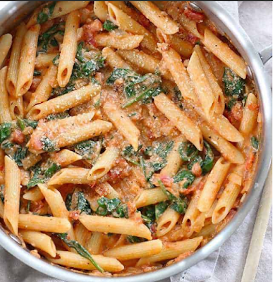 Easy wins again! I’m on day vi of associate degree eight day work week, so that means two things: I’m tired and I’m hungry. Quick skillet pasta dishes like this Creamy Tomato and Spinach Pasta are perfect for such an occasion. They require only a few ingredients, cook up super fast, and leave me feeling full and happy! :)  Anyway, tomorrow is Monday (again) and the week will be long, so I hope this recipe helps make dinner time a little faster, easier, and more enjoyable for you this week! Enjoy!  This Creamy Tomato and Spinach Pasta recipe goes great with : No Knead Focaccia Rolls, Herb Roasted Chicken Breasts, Lemony Kale & Quinoa Salad, Fudge Brownie Pots (for two)    CREAMY TOMATO AND SPINACH PASTA Close up of a skillet full of Creamy Tomato and Spinach Pasta topped with grated Parmesan SUBSTITUTIONS: This version of Creamy Tomato and Spinach Pasta uses just a touch of cream cheese and Parmesan to make a regular tomato sauce ultra rich and creamy. If you’re not into cream cheese, you could also add a splash (1/4 cup or so) of half and half to achieve a similar effect.  I used regular pasta, but whole wheat would actually be pretty good in this and would add some extra fiber and nutrients to make it a more well rounded meal.
