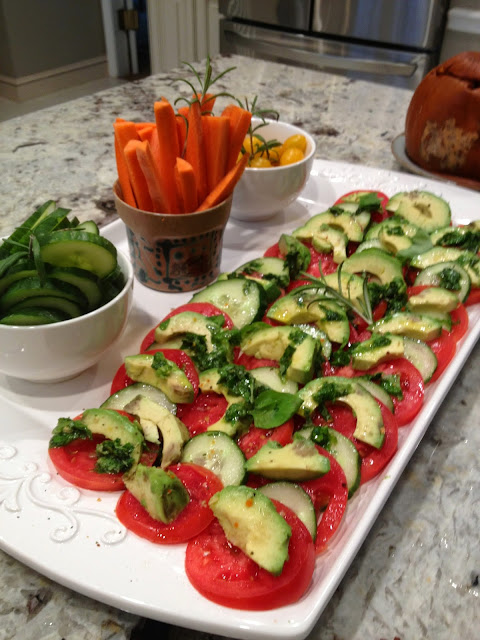 vegan appetizer display with avocado, tomatoes, basil