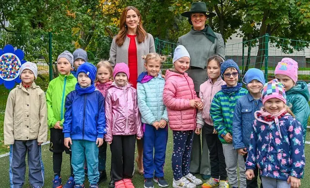 Crown Princess Mary a red contrast-stitch cady dress from Dolce & Gabbana, and double cashmere oslo coat from Joseph