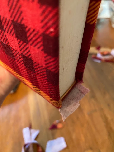 Photo of covering a hardcover book with plaid flannel.