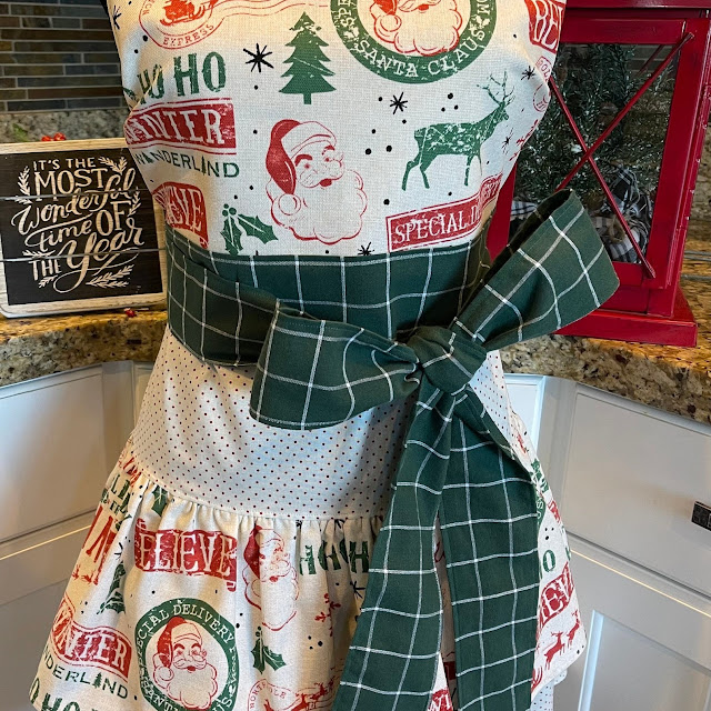 For those who embrace the spirit of Christmas, you'll love this handmade apron with its plaid, polka dot and Santa theme.