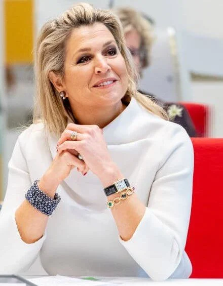 Queen Maxima wore a white silk top from Natan, and grey suede pumps from Gianvito Rossi, and the queen carried grey bag from Chanel