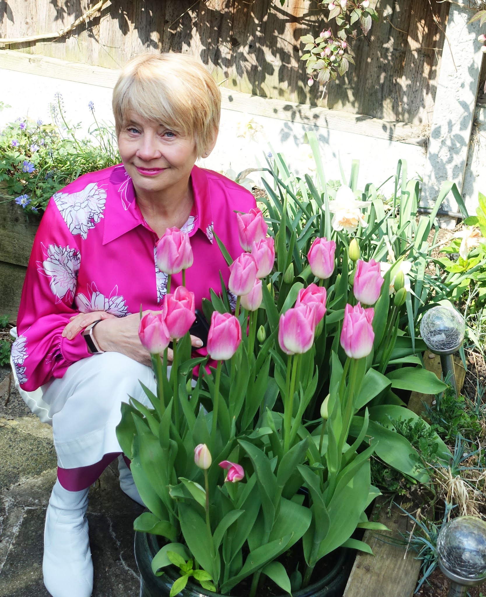 Posing in pink next to the pink tulips Dynasty: Is This Mutton blogger Gail Hanlon