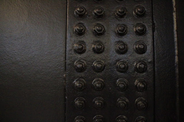image of a metal wall and metal rivets