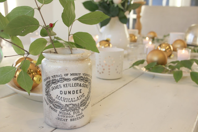 White farmhouse table with green and gold tablescape and Dundee marmalade jar as vase - Hello Lovely Studio