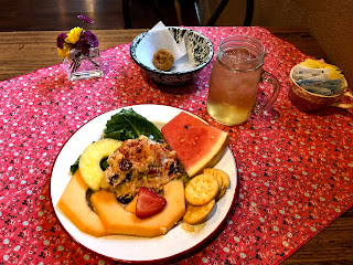 plate of fruit, salad, muffin, with a glass of iced tea
