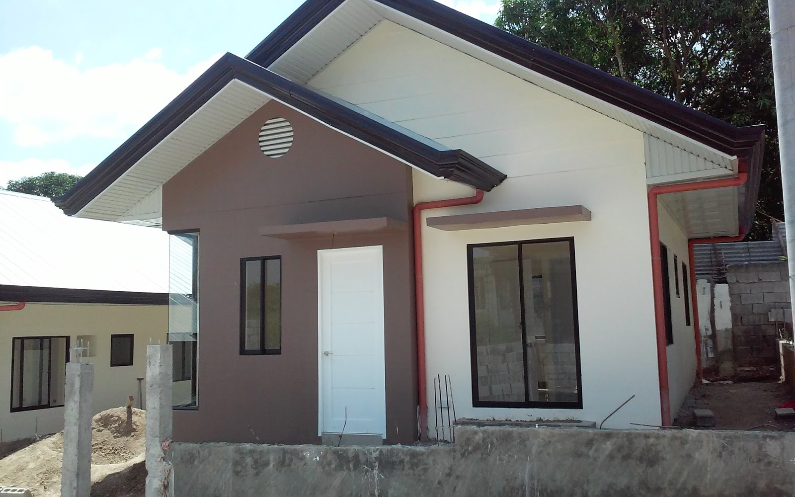 Small low-cost houses are those whose models and designs were particularly influenced by the need to keep the costs become cheaper. That might include the use of low-cost materials, simple building skills or a simple building structure. Less is more with these low-cost home designs and styles, using sustainable architecture and low-cost housing technology to build your dream home on a small budget.    These 50 Photos Of Beautiful Small Low-Cost Houses that were very low-cost to build—we show you our favorites! Which one do you like the most?       Advertisements                                               Sponsored Links                                                                 Advertisement                                                                                                      RELATED POSTS:    50 Photos Of Small And Affordable House Design For Simple And Comfortable Lifestyle   Small houses are gaining in popularity recently. Not only does it require the small land area to built, but homeowners can still enjoy a beautiful and modern style house on a smaller budget.  Small houses characterize one of modern house design patterns. Small houses mix chic and style, offering stylish and jazzy comfortable spaces with huge windows and lovely inside design. Outside seating regions around these small houses frequently furnish terrific perspectives and interface individuals with nature.    Adorable and comfortable, small houses are more affordable and pull in many individuals willing to scale down, change bigger homes for little spaces, spare cash and time for lovely exercises and treks. These collections of little inside outline thoughts present wonderful homes that are little, yet unwinding, welcoming and stylish. These little spaces offer an awesome method to rearrange life and make unwinding and agreeable way of life in a small house.    Small houses are incredible for all who can maintain a strategic distance from huge home loan installments. A commonsense purpose behind the little house configuration patterns and scaling back is a critical one. Purchasing an expansive home does not permit to spare cash on most loved exercises and long trips. They want to spare cash while making an appealing and agreeable way of life in little spaces appreciates space-sparing inside plan and smart improving small houses.      Browse our selection of small house designs to find your dream home today.   Advertisements                                               Sponsored Links                                                                                                           Advertisement                                                                                                      RELATED POSTS:    50 Photos Of Small Bungalow House Design To Help You Start Planning And Building Your Dream Small House.   Bungalow houses are usually low houses consisting of one floor. This kind of home frequently had wide verandas over the front or wrapping around the house giving extra family gathering areas.   The first bungalow houses were very small and just one story in height. Homes frequently had wide verandas over the front or wrapping around the house giving extra family gathering areas. Today bungalows are still considered to be single stories yet may incorporate incomplete second floors or space zones.    Bungalow house designs have turned into the absolute most mainstream and looked for after house designs accessible today. By deciding on bigger consolidated spaces, the intricate details of everyday life - cooking, eating and assembling - end up plainly shared encounters. What's more, an open floor design can make your home feel bigger, regardless of whether the area is modest. In this way, even a little, more affordable house design can offer the spaciousness you look for.    These small bungalow house designs may simply help make your fantasy of owning a small house a reality. Building it yourself will spare you cash and guarantee that you're getting an amazing home. You'll discover an assortment of house ideas including home designs in an assortment of sizes from the small to as extensive as you can get the chance to be viewed as a small home. The styles may vary as well, so make sure to look at them all.    Space Saving House Design Ideas: Find The Perfect Design For Your New Home   Do you believe in perfect homes? Ideally, homes are really who lives inside. It doesn't have to look perfect, but we cannot ignore the fact that the ambiance also plays a great role in maintaining a house you can call home.