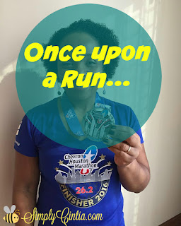 A marathon runner holds her finisher's medal. 