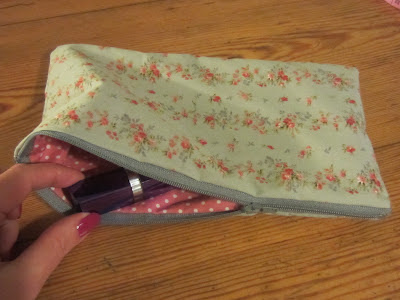 Hand sewn zip purse or make up bag with floral pattern and pink polka dot lining