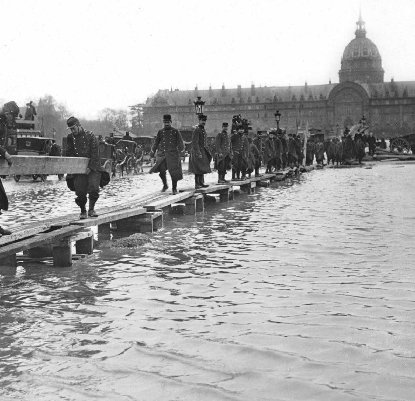 The army lays down a wooden walkway.