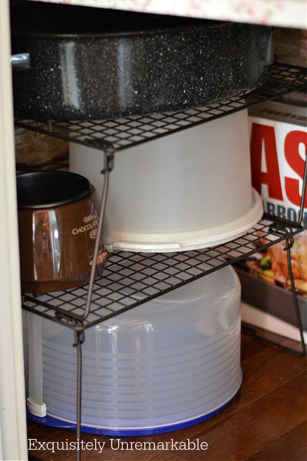 Stackable Wire Shelves on floor of pantry with cake keepers on top