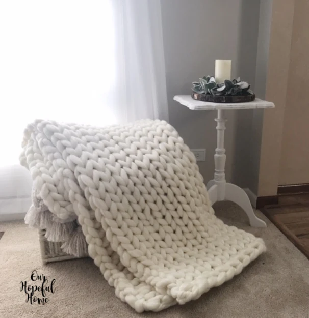 chunky knit throw blanket hygge white painted side table LED candle
