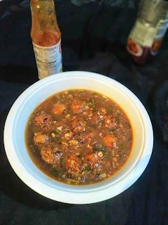 Serving veg manchurian gravy in a bowl.