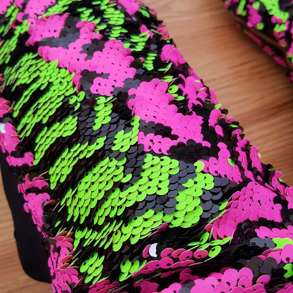 close up of lime and pink and black zebra pattern sequins on boots
