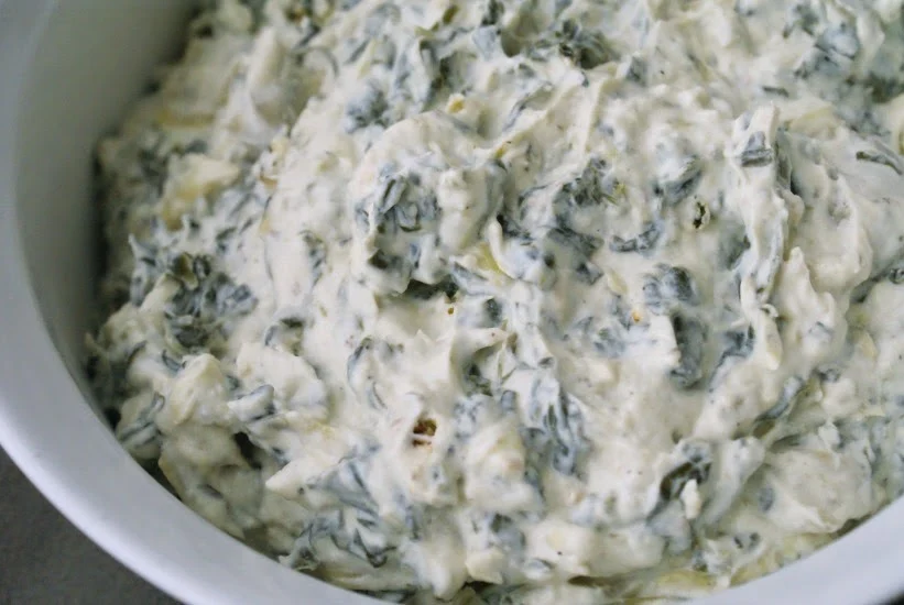 Spinach Artichoke Dip that is cooked in a crock pot.