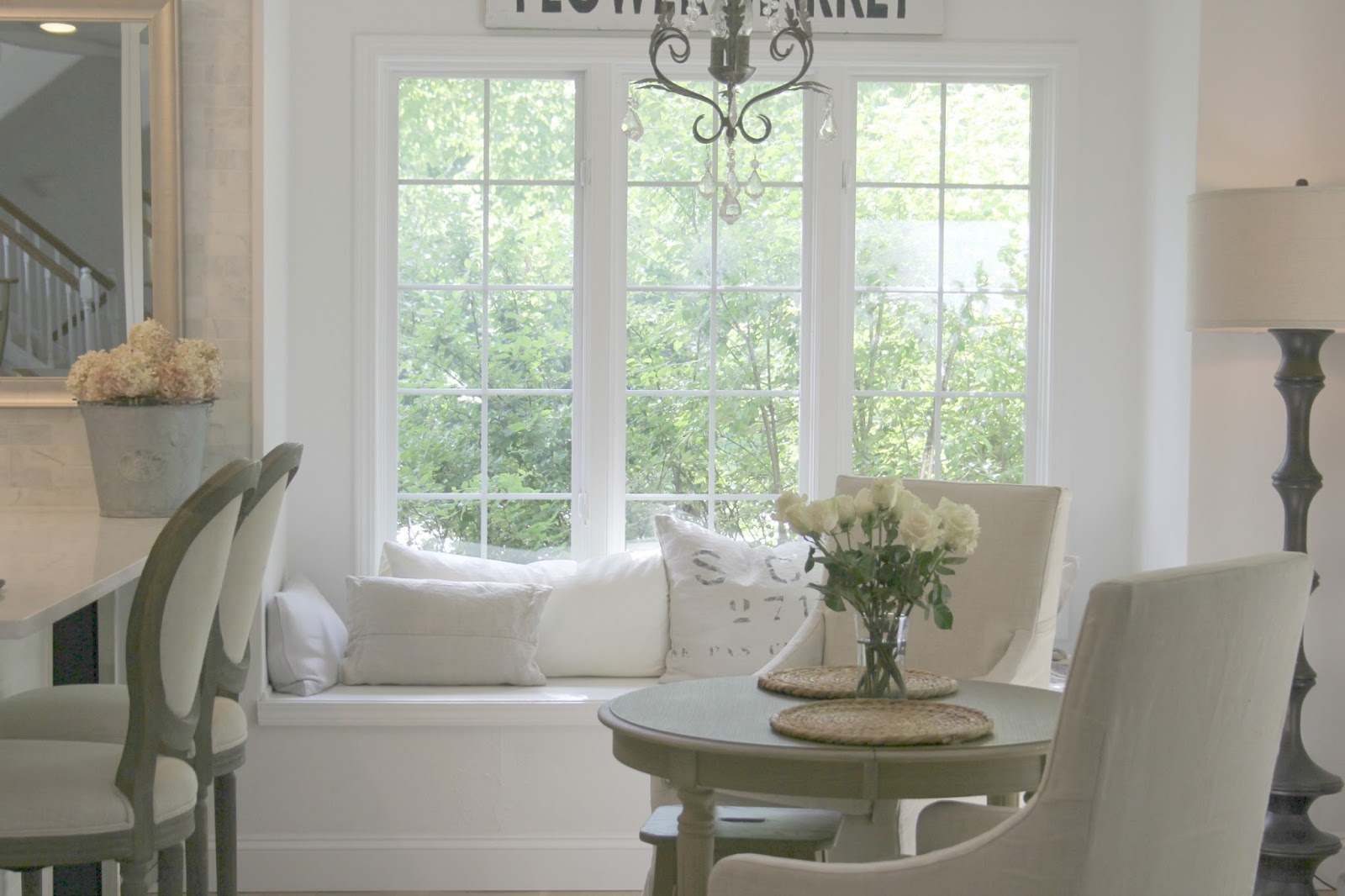 Hello Lovely's modern French kitchen with white walls, window seat, Belgian linen, and serene tone on tone vibe.