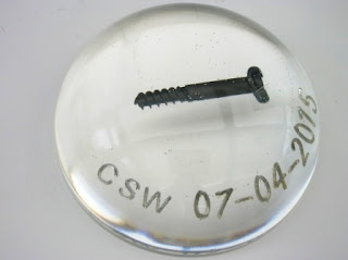 Medical screw set within a paperweight