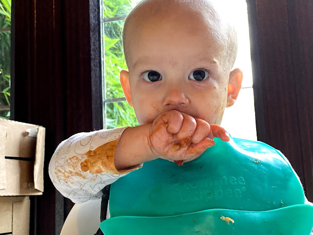 Tomato sauce on baby's clothes from BLWing A baby making a mess of his clothes while BLW Baby Led Weaning
