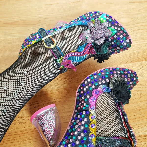 wearing jewelled T-bar shoes with acrylic seahorse detail and fishnet tights