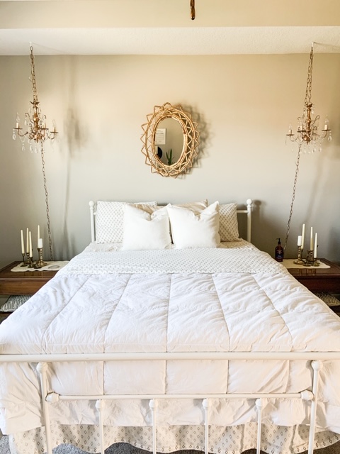 vintage rattan mirror over bed