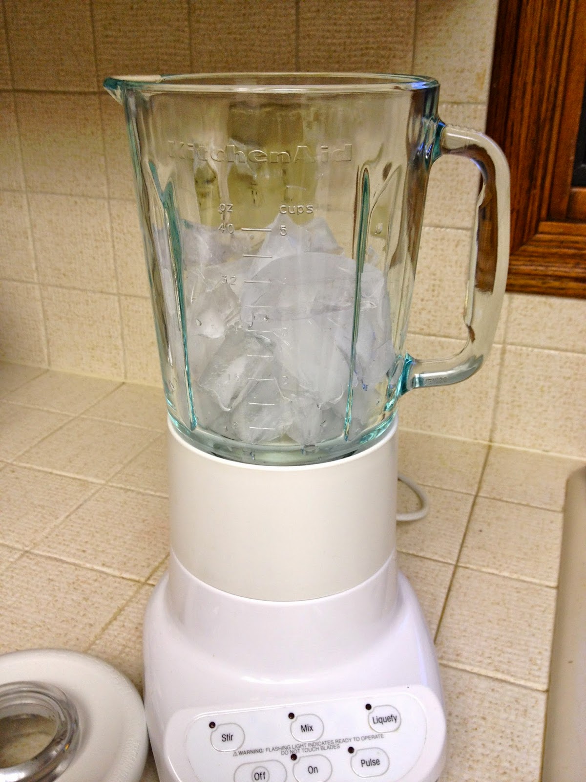 Fill 12 of the blender with ice cubes.