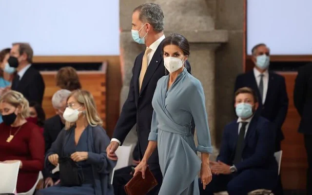 Queen Letizia wore a new wrap around dress by Adolfo Dominguez. Red pumps by Magrit. Earrings by Tous jewelry