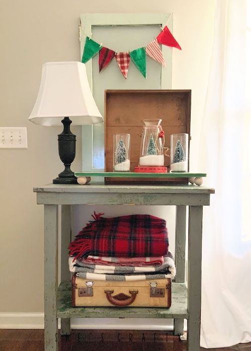 Christmas Vignette with DIY snow globes and bottle brush trees, plaid bunting, plaid blankets