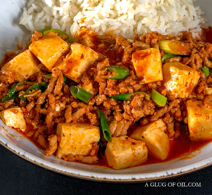 Mapo Tofu - a delicious pork stir-fry recipe. Mapo tofu, pictured in a bowl with rice.