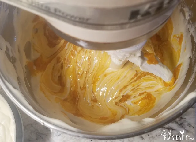 mixing pumpkin into cheesecake batter