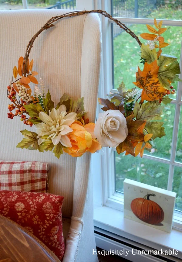 Fall Wreath hanging on a chair with pillows