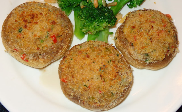 MUSHROOMS STUFFED WITH CRAB CLAWS MEAT PORTIONS: 3 INGREDIENTS 9 large white mushrooms 2 tbsp. lemon juice ½ lb. / 227 g crab claws meat 3 tbsp. soft butter ¾ cup onions, diced 1 garlic clove minced ¼ cup green peppers, diced  1/3 cup red peppers diced 1½ tbsp. chopped parsley 3 tbsp. all-purpose flour ¾ cup milk ¼ tsp. ground black pepper ½ tsp. salt 2 tbsp. Panko bread crumbs Olive oil spray METHOD Remove the mushrooms stems and save for a soup or rice. Wash de mushrooms and dry with paper towel. Brush with lemon juice the mushrooms caps. At moderate flame, melt the butter in a frying pan and sauté the garlic and onion until transparent.  Add and cook peppers for 1 minute. Stir in the flour and cook until is lightly brown. Incorporate the milk and mix well. Let it cook and mix for about 5 minutes making sure it does not burn. Add crab meat, parsley, pepper and salt mixing well. Set the oven in slow broiler and heat it. Stuff the mushrooms caps with the crab meat mix and sprinkle top with bread crumbs. Spray the caps tops with olive oil. Place the mushrooms in baking tray and broil them for about 14 minutes. Top of the mushrooms should be lightly brown and caps soft. BROCCOLI WITH SLIVERED ALMONDS AND GARLIC PORTIONS: 3 INGREDIENTS 12 oz. / 338 g. broccoli florets 1 tbsp. olive oil 1 tbsp. butter 2 garlic cloves chopped 1/3 cup slivered almonds Salt and pepper to taste METHOD Boil some water in a pot with 2 tsp. salt and cook the broccoli florets al dente. Meanwhile at moderate flame heat up a pan with the olive oil and melt butter.  Add garlic, slivered almonds and lightly brown it. Drain the broccoli florets and mix with the browned garlic and almonds, Season it with salt and pepper. Serve the broccoli with the mushrooms caps.