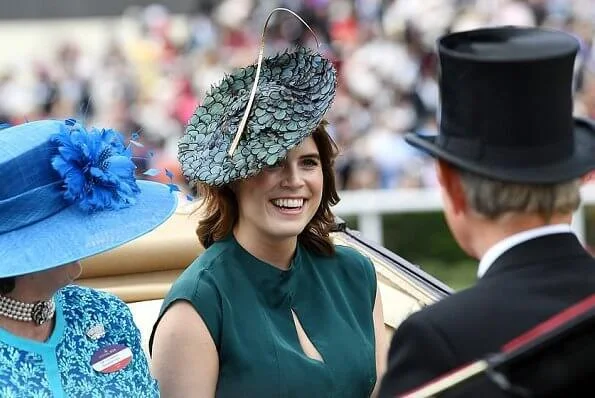 The Countess of Wessex wore a  wide-leg jumpsuit by Emilia Wickstead. Princess Eugenie wore a belted silk satin midi dress by Cefinn