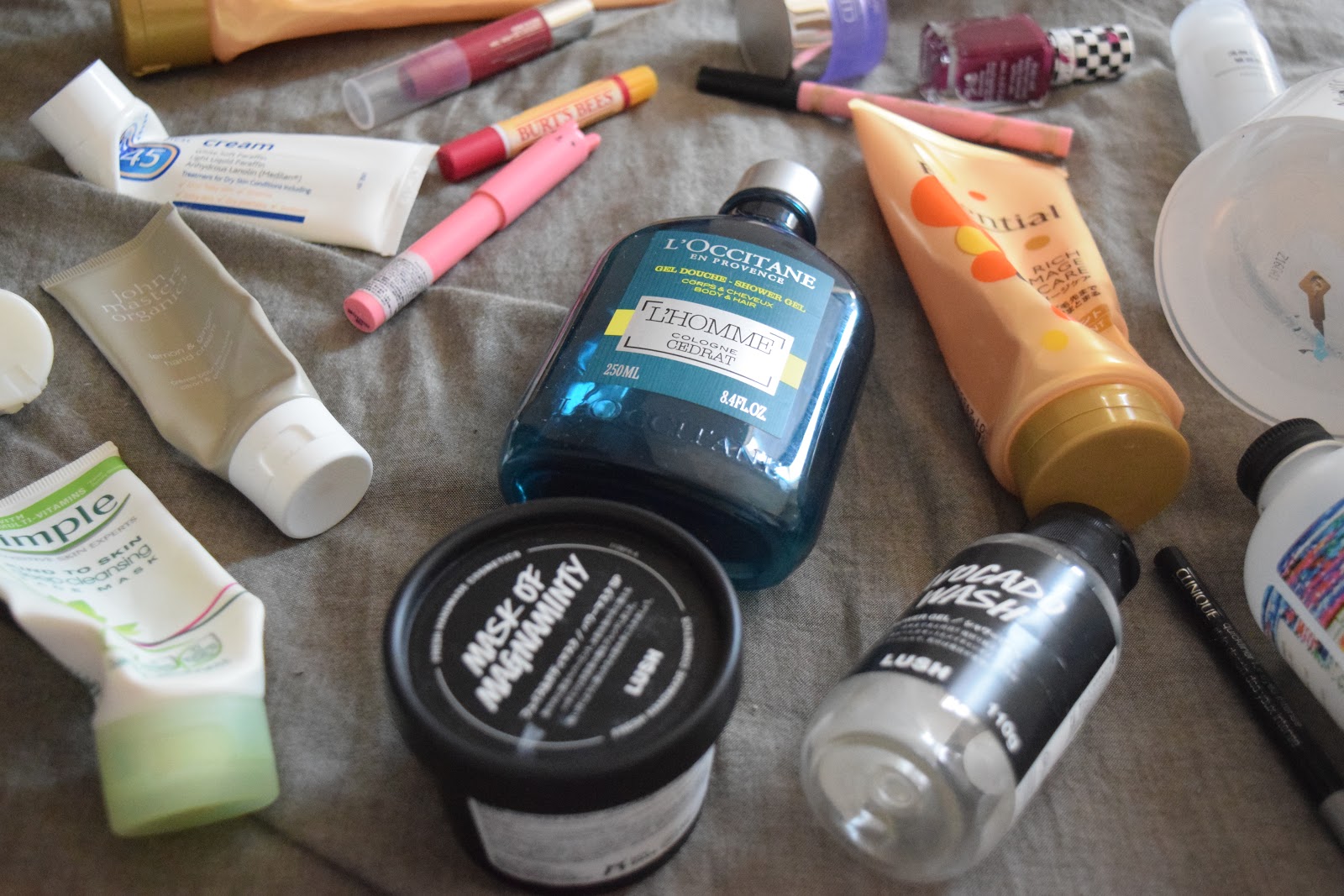 Flatlay of empty beauty products including skincare, makeup and hair care