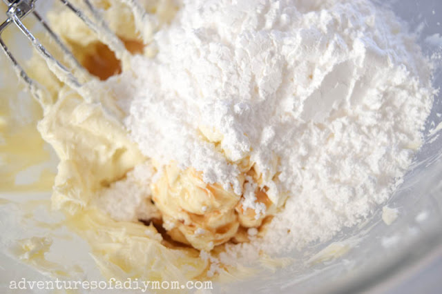 adding powdered sugar, vanilla and milk to cream cheese frosting