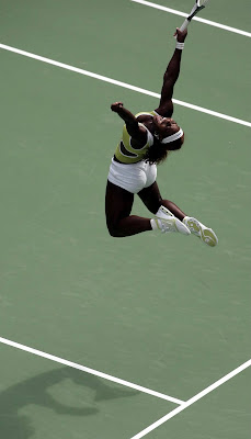 Serena Williams jumping in mid-air above a tennis court