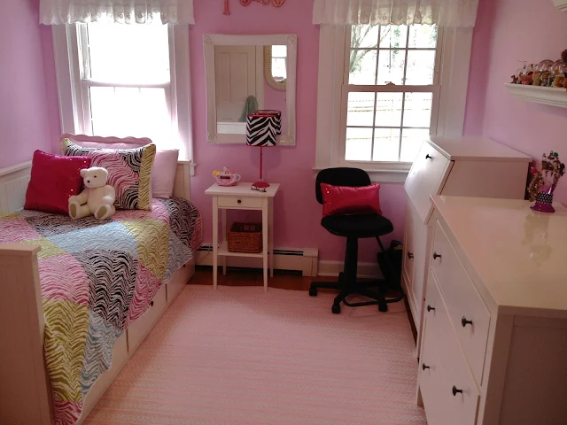 Pink tween girl's bedroom with rainbow zebra quilt