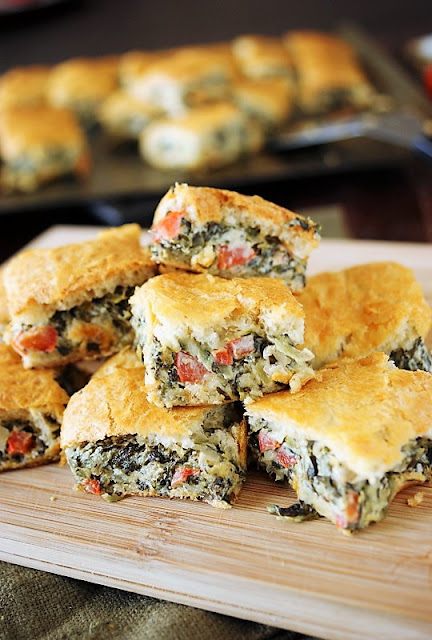 Spinach Dip Crescent Bites Image ~ all the goodness of spinach dip, baked up between flaky layers of crescent rolls!  Perfect for any party menu.
