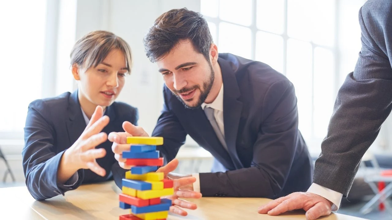 Business team buidling exercise for creative teamwork with blocks.