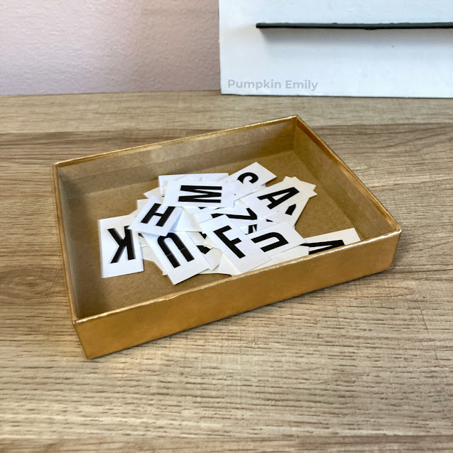 letters for a letter board sitting in a box lid